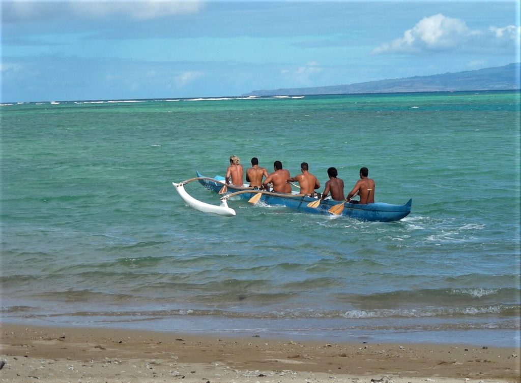 Outrigger canoe leaving a Maui beach 
