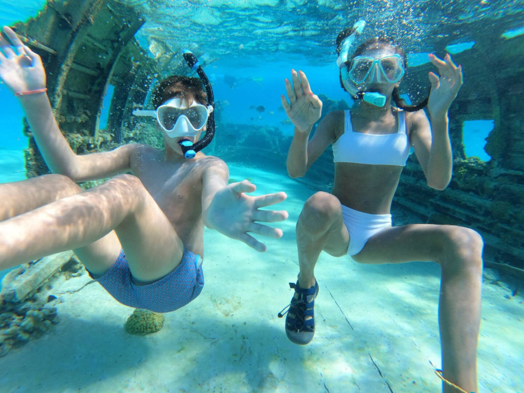 kids snorkeling at the plane wreck on Normans Cay, Bahamas