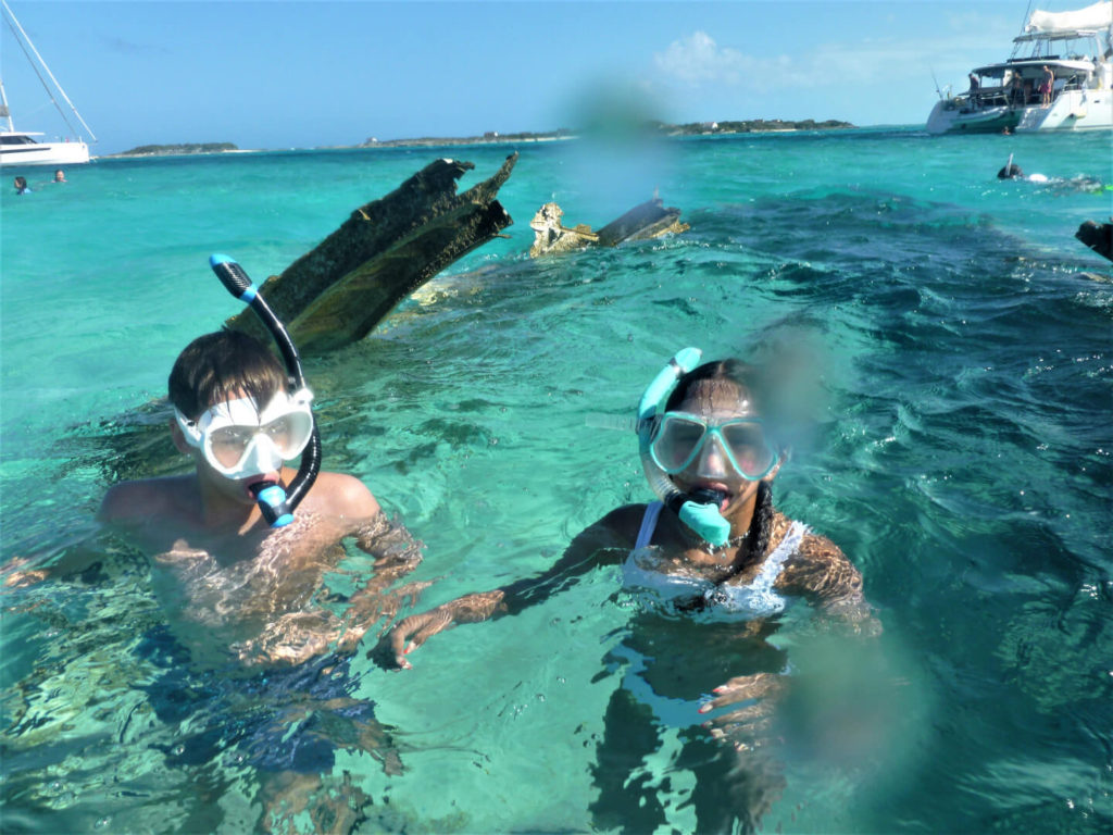 kids snorkeling at the plane wreck on Normans Cay, Bahamas