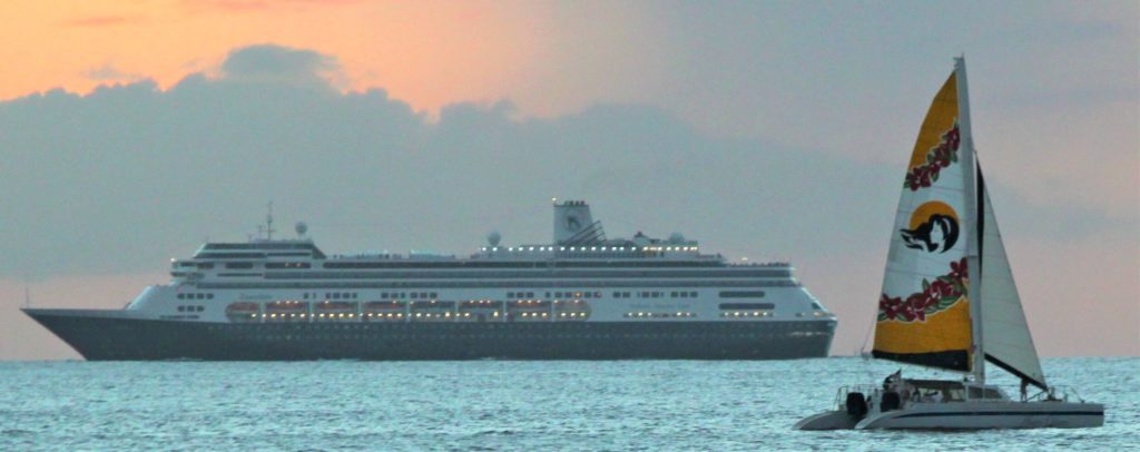 The Spirit of Alhoa sails past a cruise ship off the coast of Oahu, Hawaii