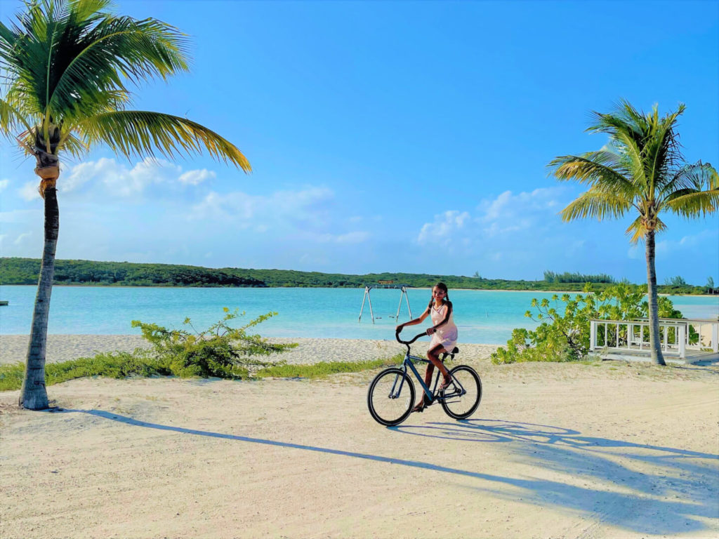 Riding a bike along the beach at Highbourne Cay, Bahamas