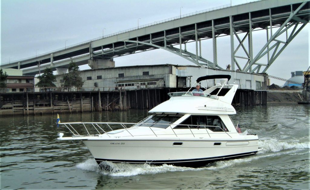 'Wright One' Bayliner 3388 Command Bridge Motoryacht passing the Fremont Bridge on the Willamette River in Portland, Oregon