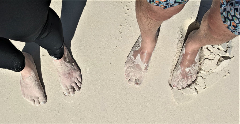 feet in the sand at Shroud Cay, Bahamas