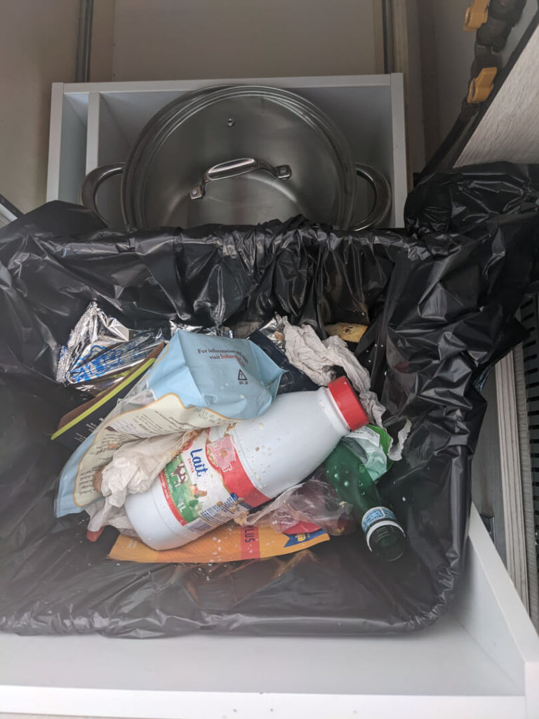 Storage space behind the garbage can