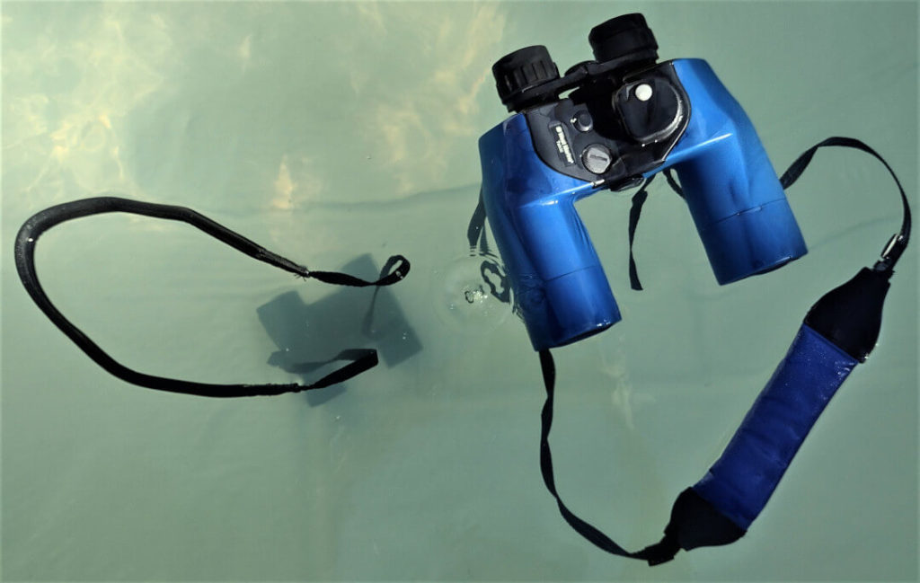 West Marine Tahiti binoculars floating next to Bushnell H2O Binoculars that sank
