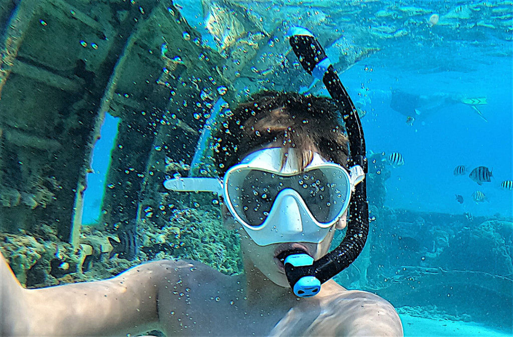 Snorkeler in the water with Cressi F1 Frameless goggles and Cressie Supernova Snorkel